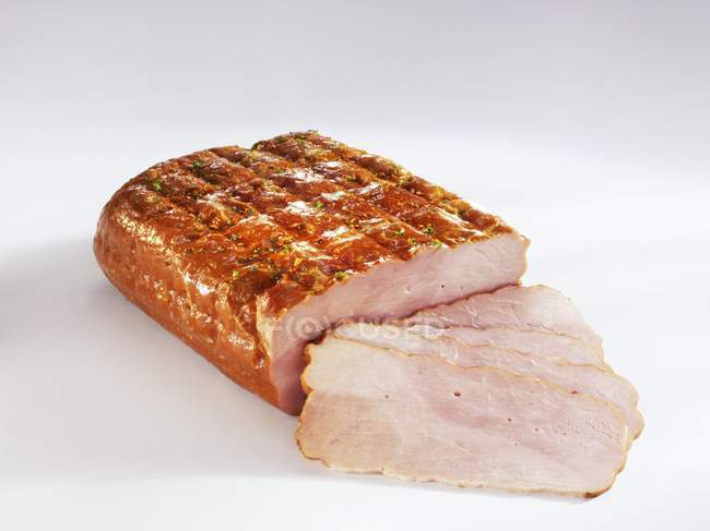 Partly sliced roasted ham — Stock Photo