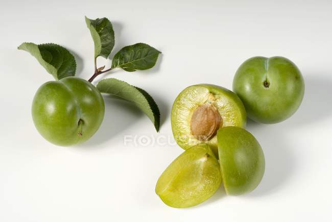 Fresh Whole and half greengages — Stock Photo