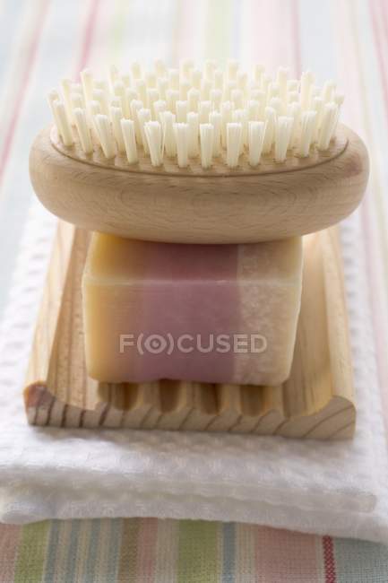 Closeup view of perfumed soap in soap dish with brush — Stock Photo