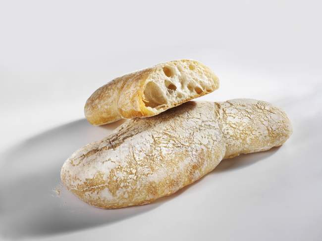 Целые и наполовину чиабатта хлебы — стоковое фото