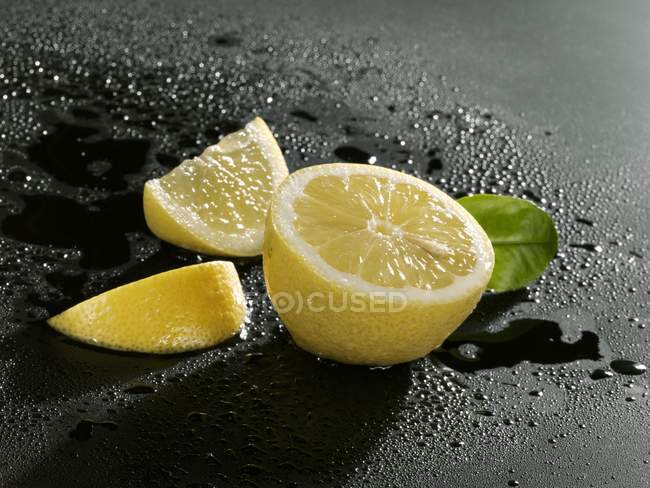 Fresh sliced lemon with leaf — Stock Photo