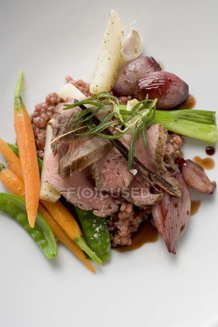 Roasted beef on vegetables — Stock Photo