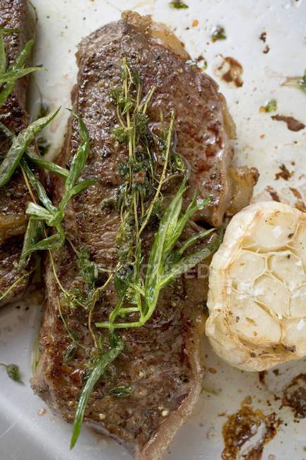 Beef steaks with herbs — Stock Photo