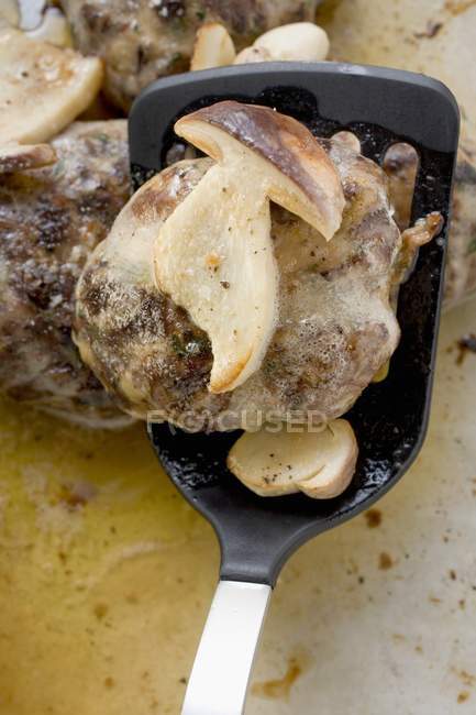 Burger with fried cep on spatula — Stock Photo