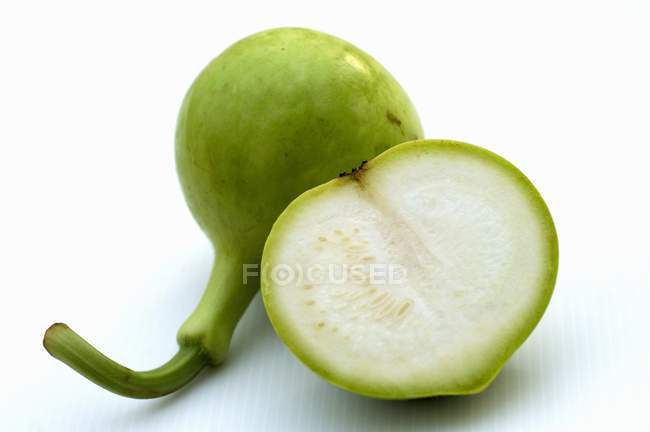 Half and whole nam tao - Bottle gourd over white surface — Stock Photo
