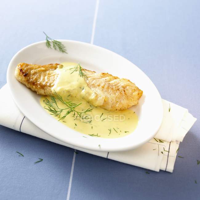 Fried cod fillet in mustard sauce — Stock Photo