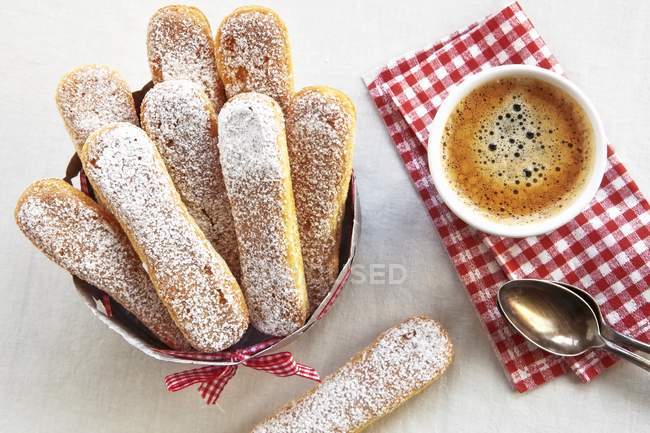 Top view of sponge fingers and coffee cup — Stock Photo