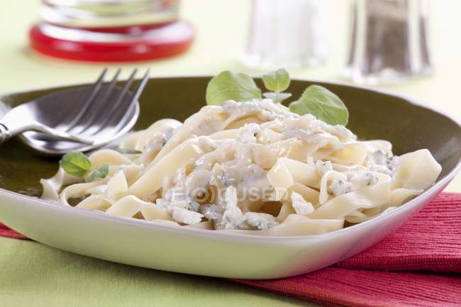 Tagliatelle pasta with cheese sauce — Stock Photo