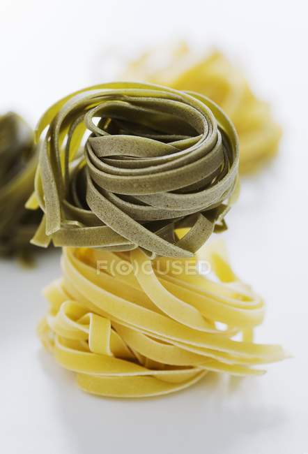 Raw tagliatelle pasta nests — Stock Photo