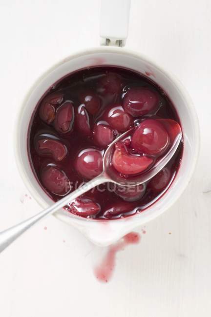 Cherry compote in pan — Stock Photo