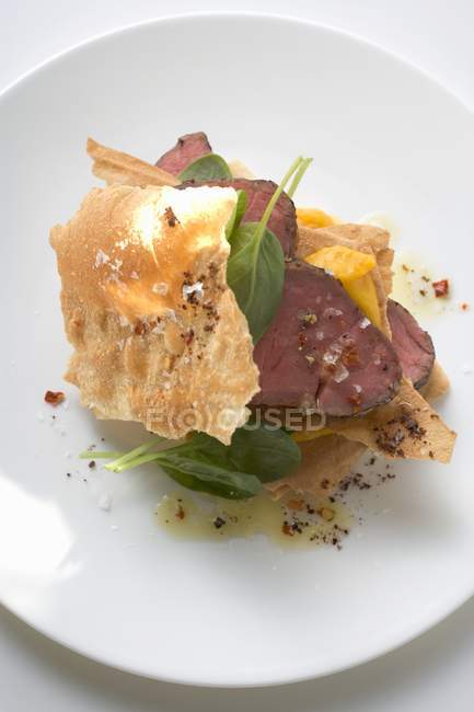 Beef fillet in pastry with basil and mango — Stock Photo