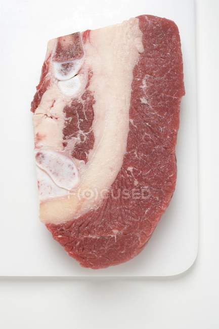 Raw Beef brisket on chopping board — Stock Photo