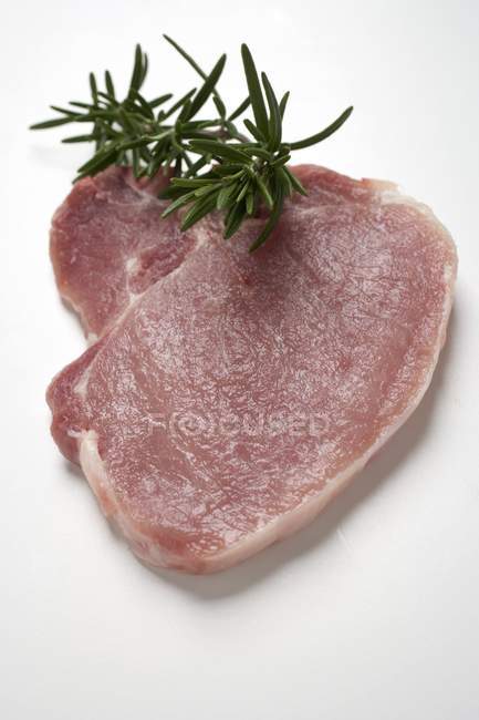 Raw pork chop with rosemary — Stock Photo