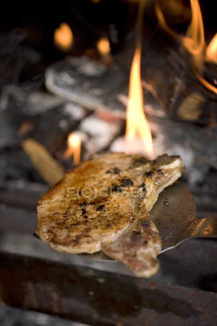 Fried pork chop on spatula — Stock Photo