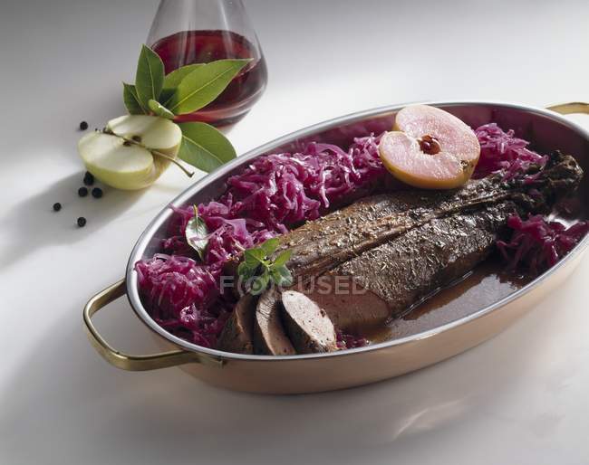 Closeup view of venison meat with red cabbage and apples — Stock Photo