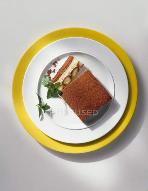 Tiramisu on plates and on table — Stock Photo
