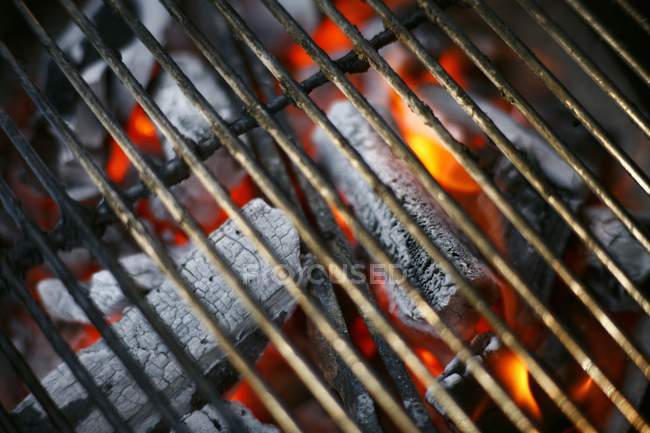 Closeup view of glowing coals under barbecue rack — Stock Photo