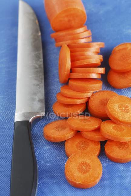 Möhren und Messer in Scheiben geschnitten — Stockfoto