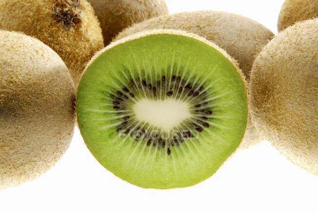 Metade e frutas kiwi inteiras — Fotografia de Stock