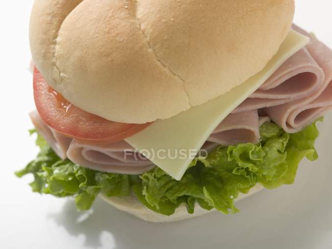 Bread roll filled with ham — Stock Photo