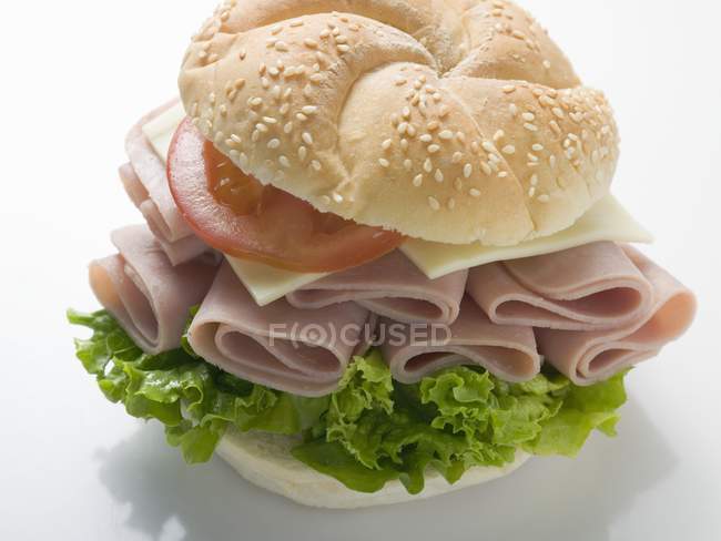 Sesame roll filled with ham — Stock Photo