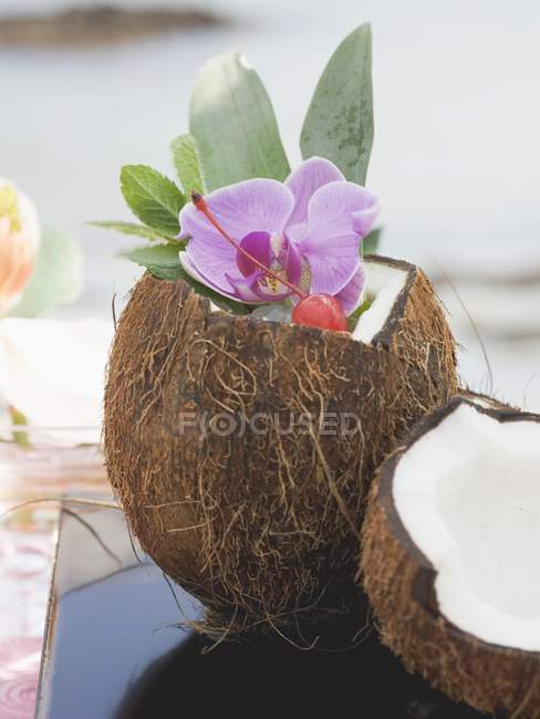Открыт кокос с мятой и орхидеей — стоковое фото