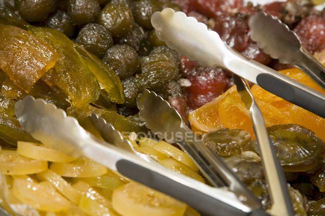 Closeup view of candied fruit and servers — Stock Photo