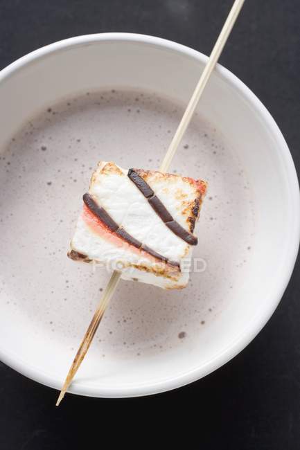 Cocoa with marshmallow on stick — Stock Photo