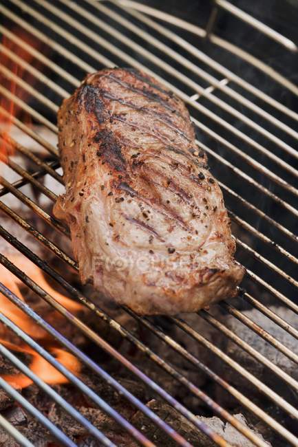 Beef steak on rack — Stock Photo