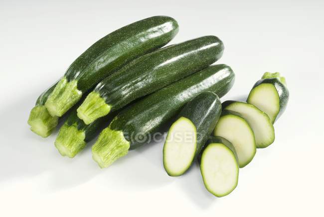 Fresh green courgettes with slices — Stock Photo