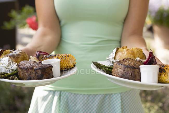 Woman serving two plates — Stock Photo