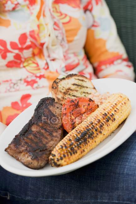 Woman holding  plate — Stock Photo
