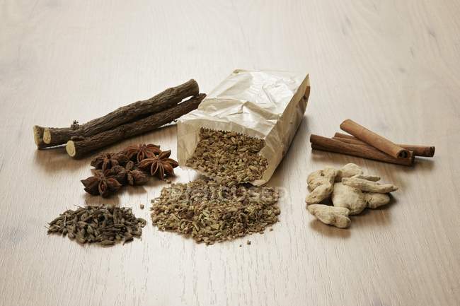 Tea ingredients on wooden surface — Stock Photo