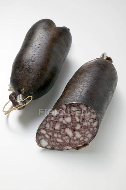 Black pudding whole and sliced — Stock Photo