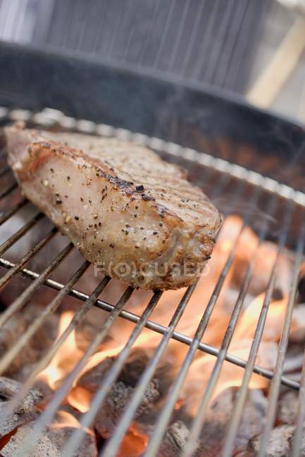 Beefsteaks on barbecue outdoors — Stock Photo