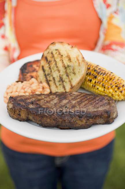 Woman holding plate — Stock Photo