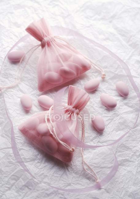 Closeup view of sugared almonds in fabric bags — Stock Photo