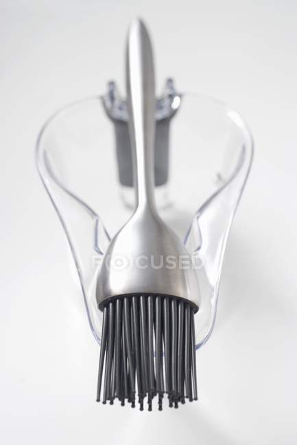 Closeup view of barbecue brush on glass sauce-boat — Stock Photo