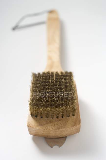 Closeup view of one wire brush on white surface — Stock Photo