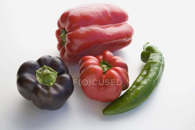 Red, purple and chili peppers — Stock Photo