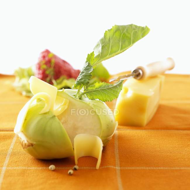 Kohlrabi with cheese on cloth — Stock Photo