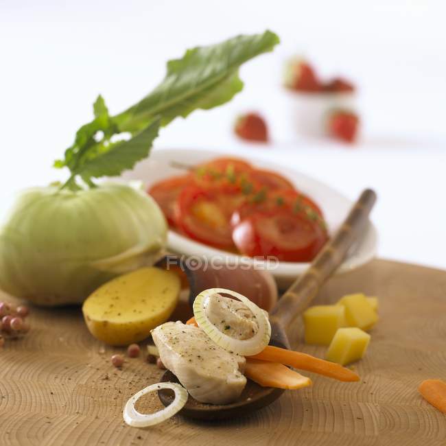 Ingredients for vegetable stew with chicken on wooden desk — Stock Photo