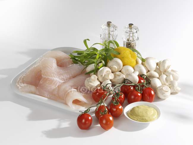Fresh fish fillets with vegetables — Stock Photo