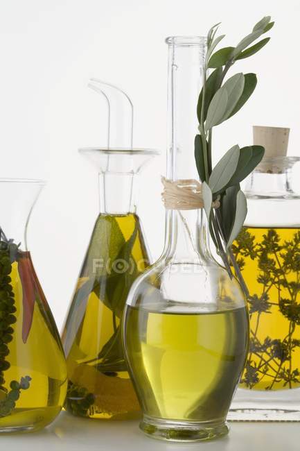 Closeup view of various oils with herbs and spices — Stock Photo