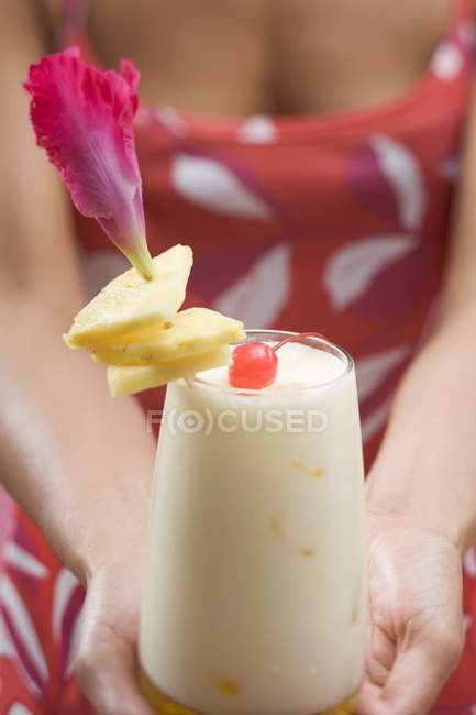 Closeup cropped view of woman holding Pina Colada cocktail — Stock Photo