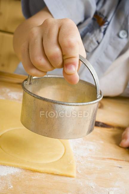 Child cutting out biscuits — Stock Photo