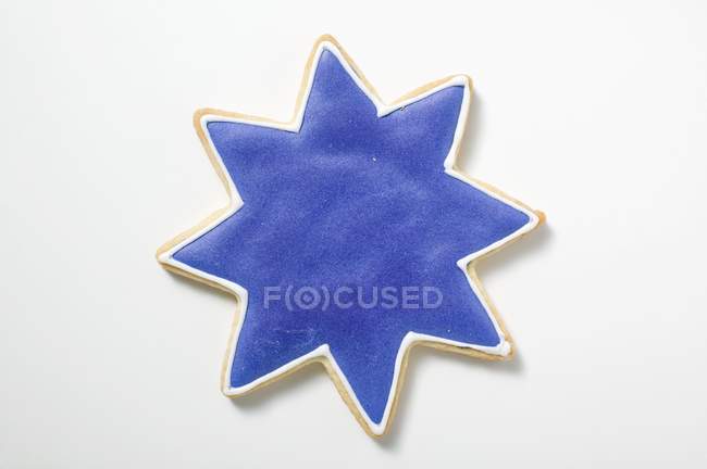 Closeup top view of star-shaped cookie with blue icing — Stock Photo