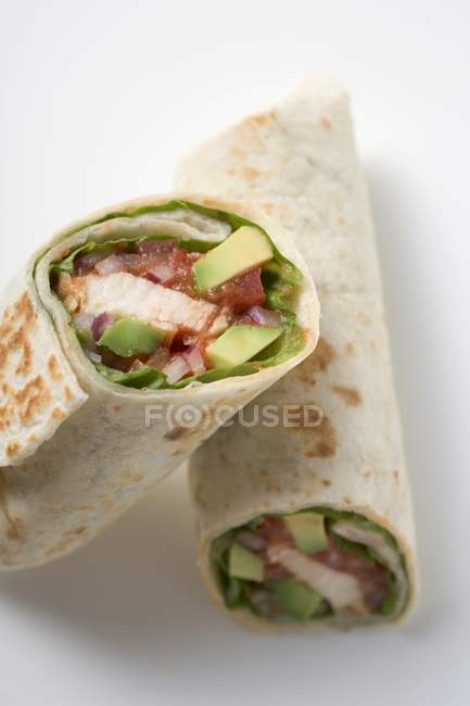 Closeup view of two wraps filled with chicken and avocado — Stock Photo