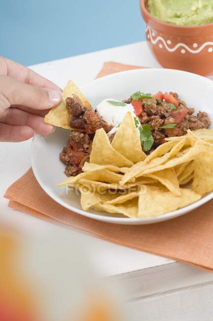 Hand dipping tortilla — Stock Photo