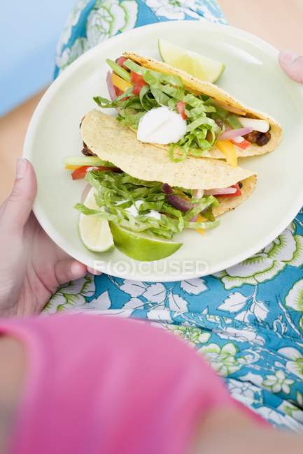 Woman holding plate — Stock Photo